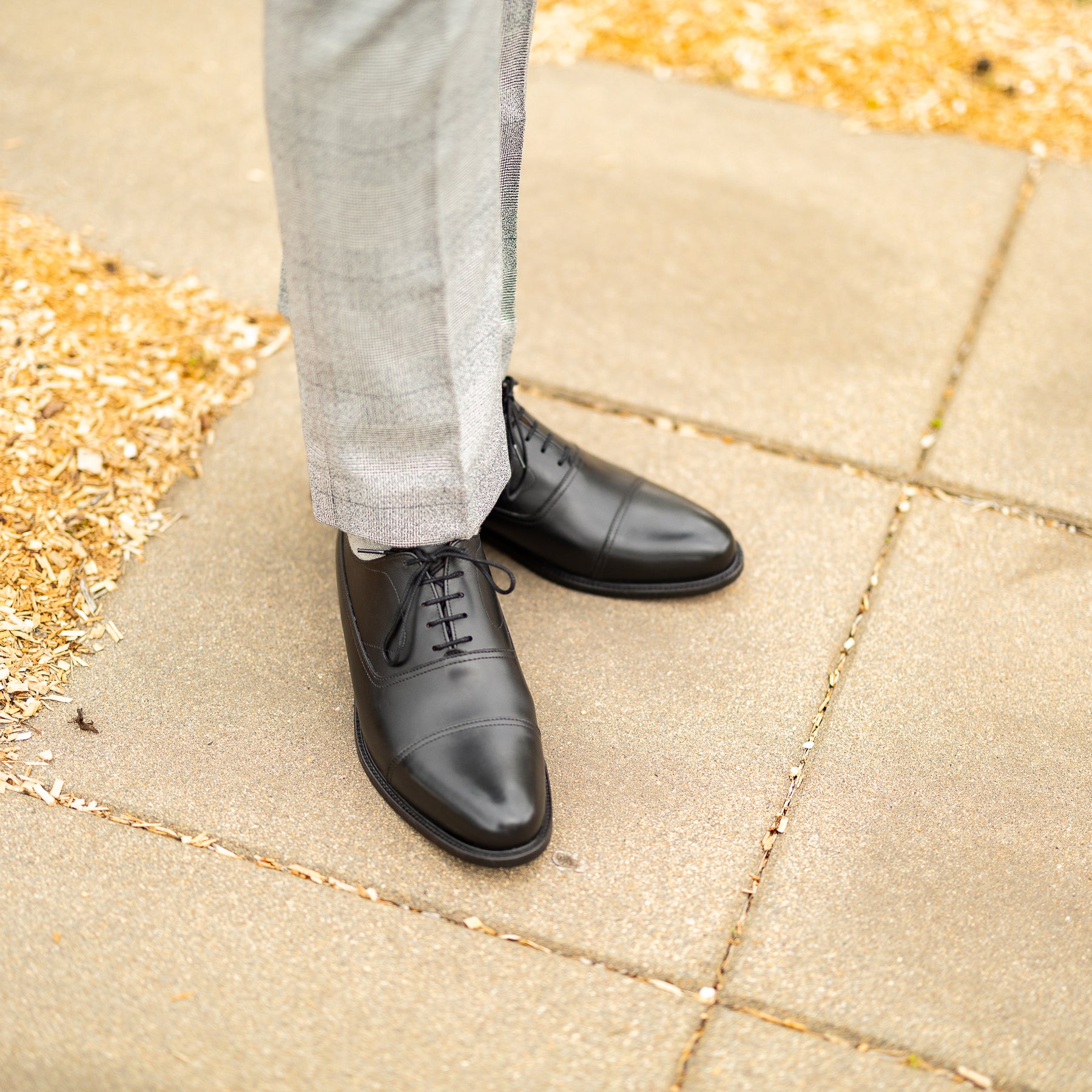 Mens black formal shoes with a suit or tuxedo for groomsmen, office settings and business