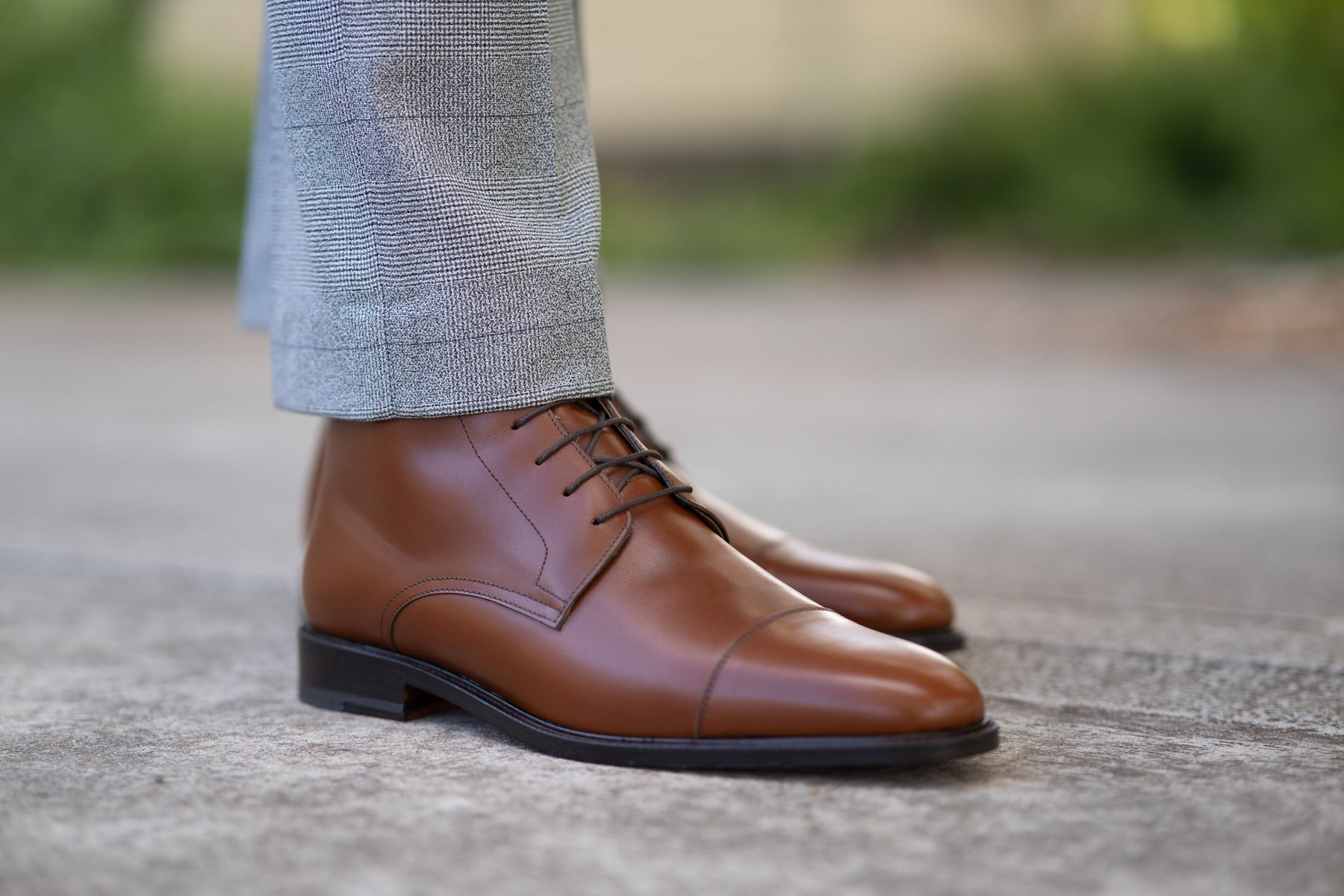 Mens light tan dress boots featuring lace up fastening and worn with gent tailored button plain suit