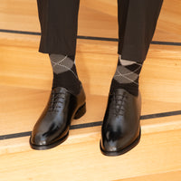 Mens black oxford shoes with wholecut design made using single piece of calf leather and paired with suits