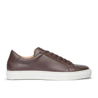 Brown leather dress sneakers featuring full grain calfskin and white rubber sole