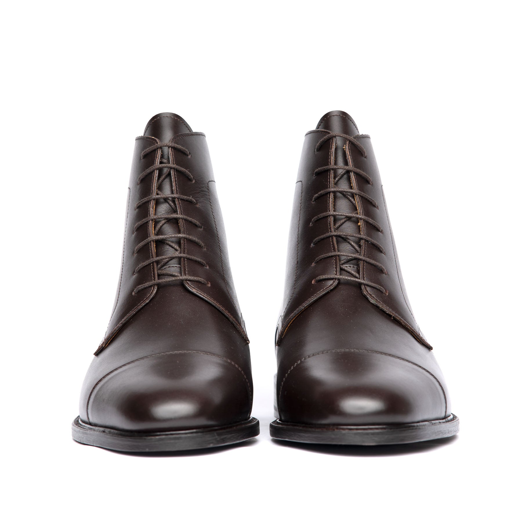 Brown leather lace up boots featuring front lace fastening and blind eyelets with leather sole