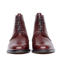 Burgundy dress boots featuring full grain leather, open lace system and patina on the toe cap