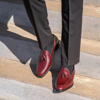 Mens burgundy tassel loafers made using blake rapid stitched construction and worn black cotton socks