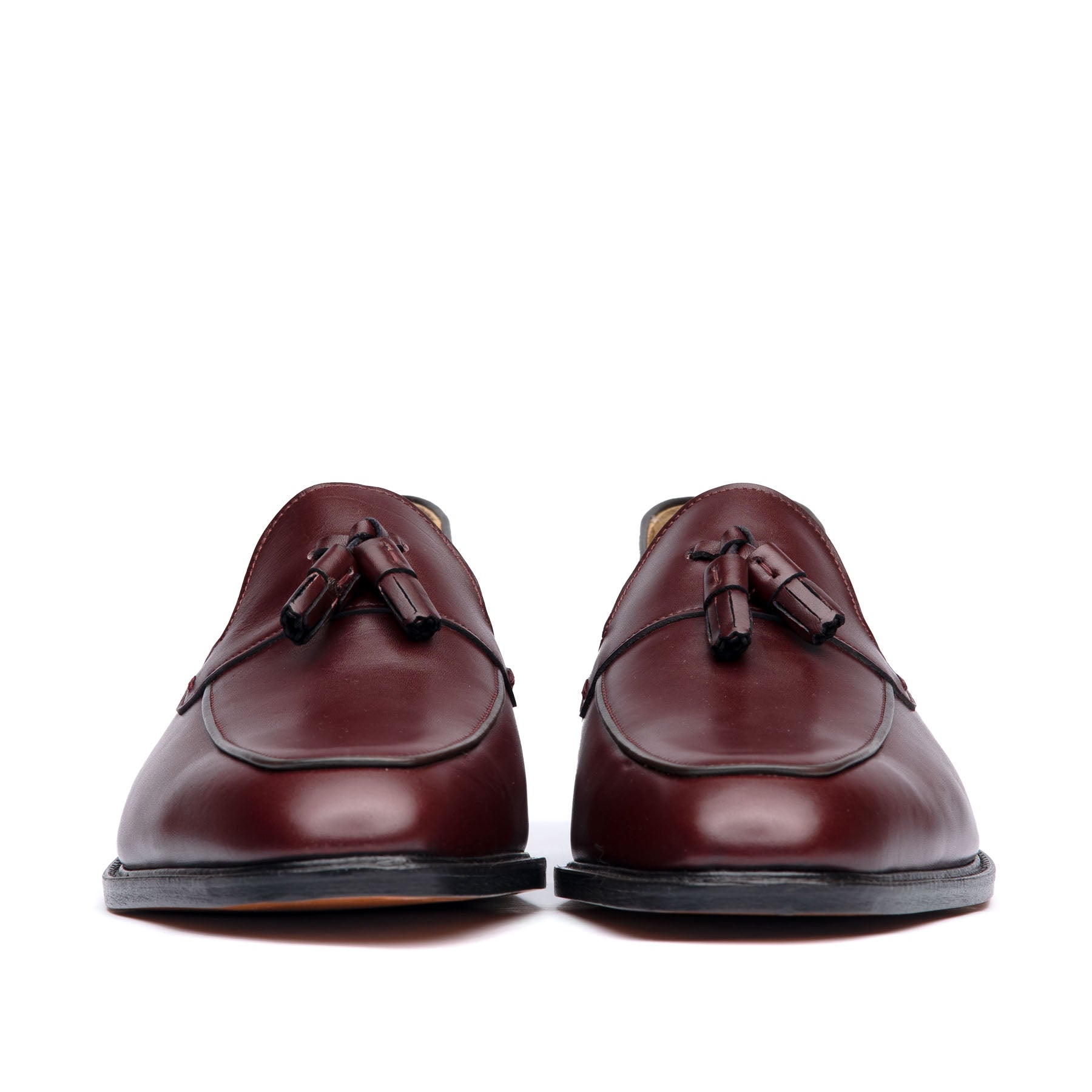 Burgundy loafer with handmade tassel at the vamp and beautiful patina at the top cap