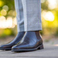 Leather chelsea boots in dark brown leather worn with tuxedo grey suit and cotton socks