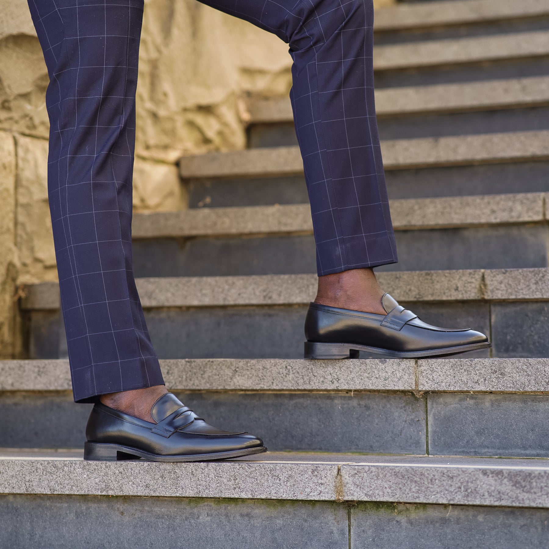 Mens black loafer paired with merino wool suit pant