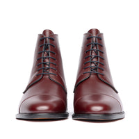 Mens burgundy boots with open lace system and double stitching at the toe cap