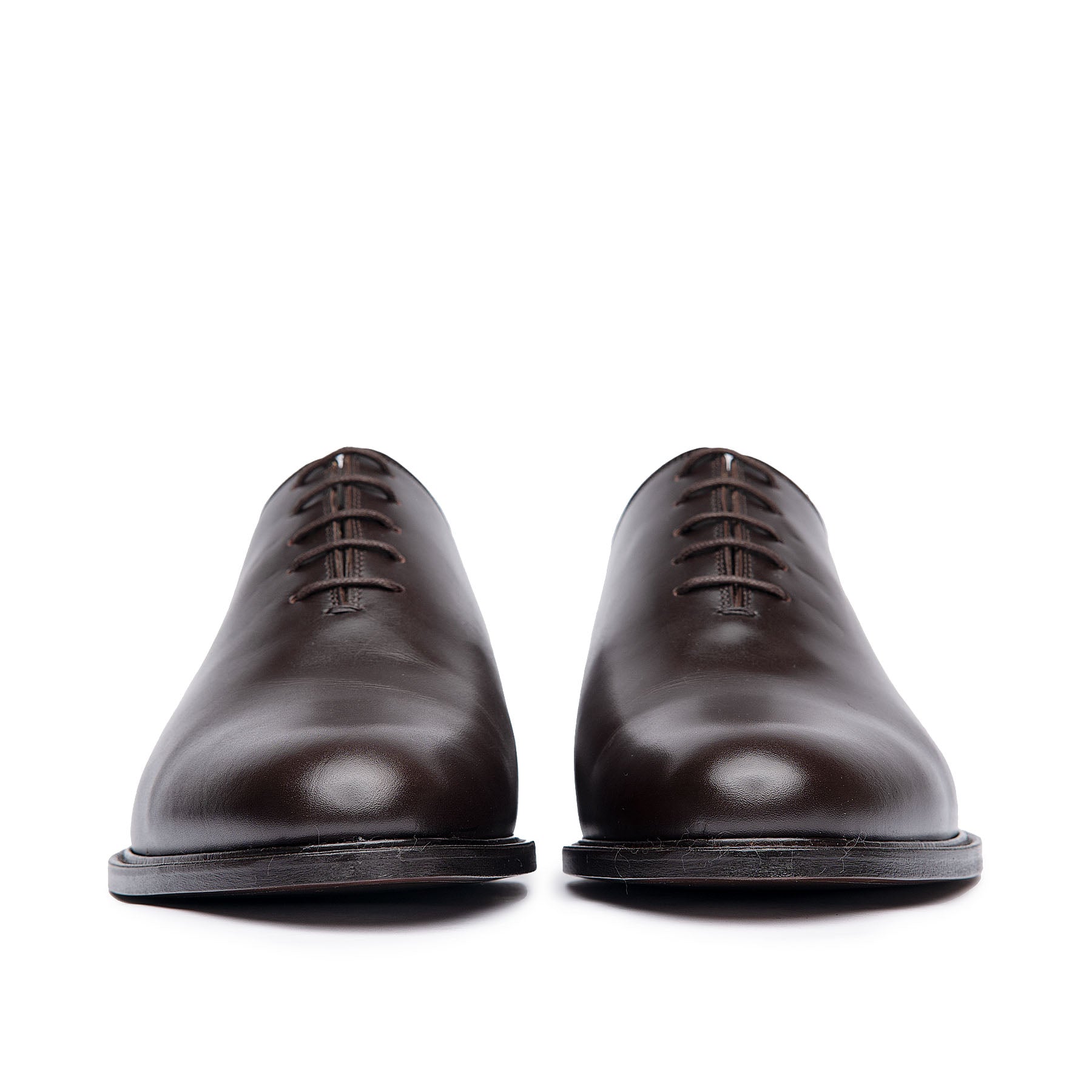 Men's leather dress shoes made from single piece of calfskin with beautiful patina at the top cap.