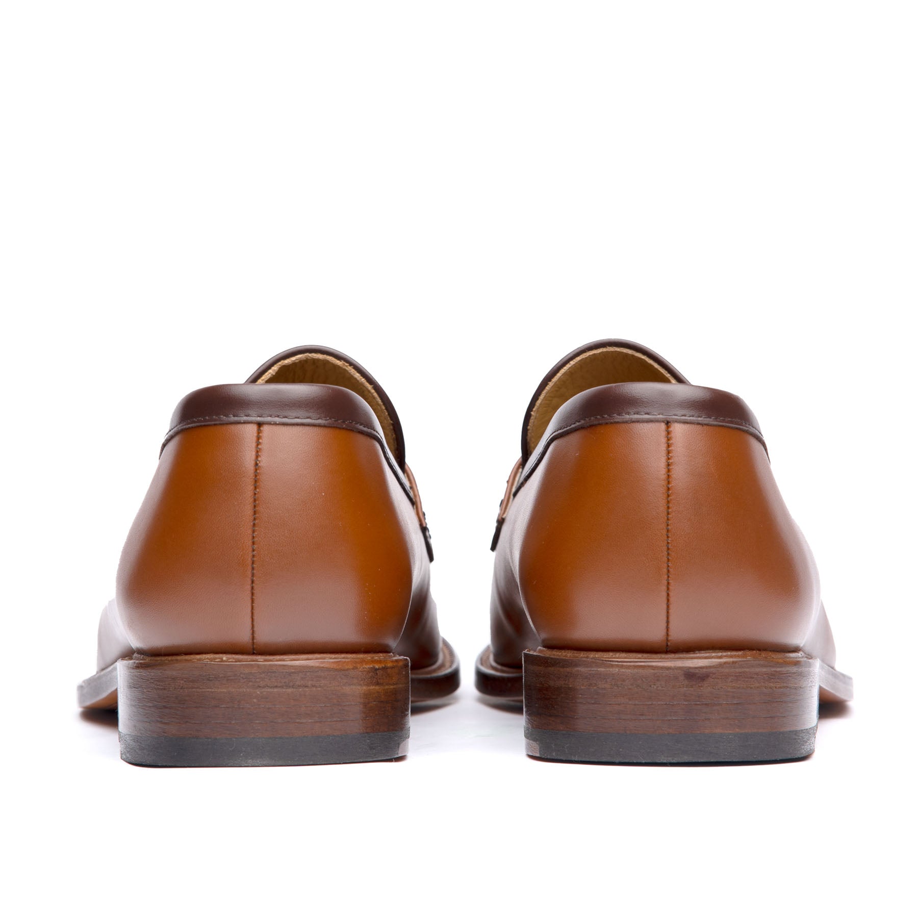 Tan penny loafers with stacked leather heel and rubber injection for traction
