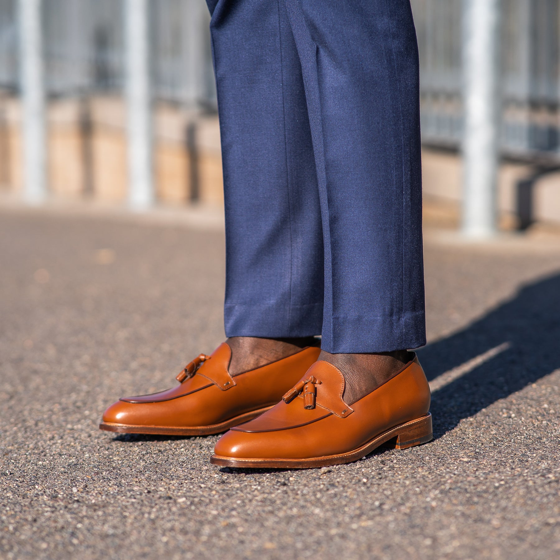 Tan tassel loafers paired with Italian bespoke blue suit