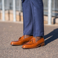 Tan tassel loafers paired with Italian bespoke blue suit