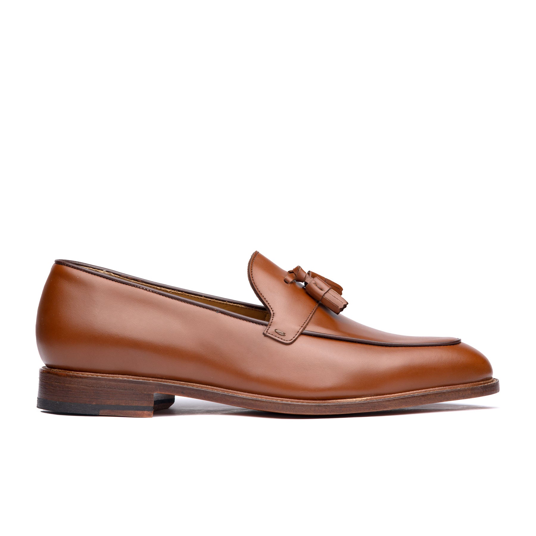 Leather tan loafers with handmade tassel complement smart casual outfits