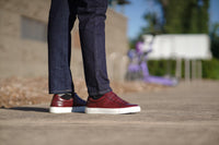Sneaker dress shoes for men styled with blue jeans and jacket