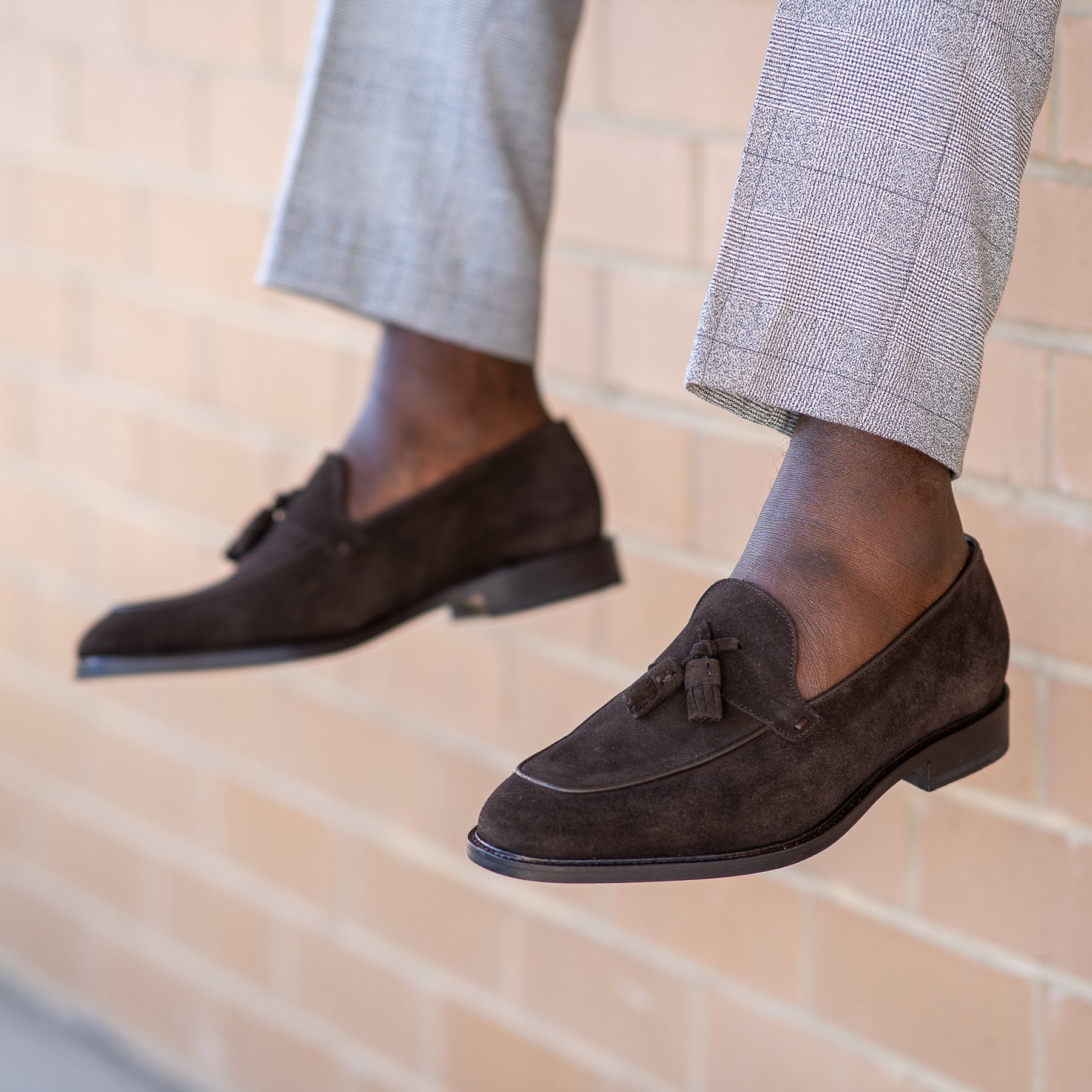 Brown suede tassel loafers, paired with grey Italian merino wool woven trousers
