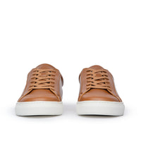 Tan trainers featuring low top design and white rubber sole for comfort