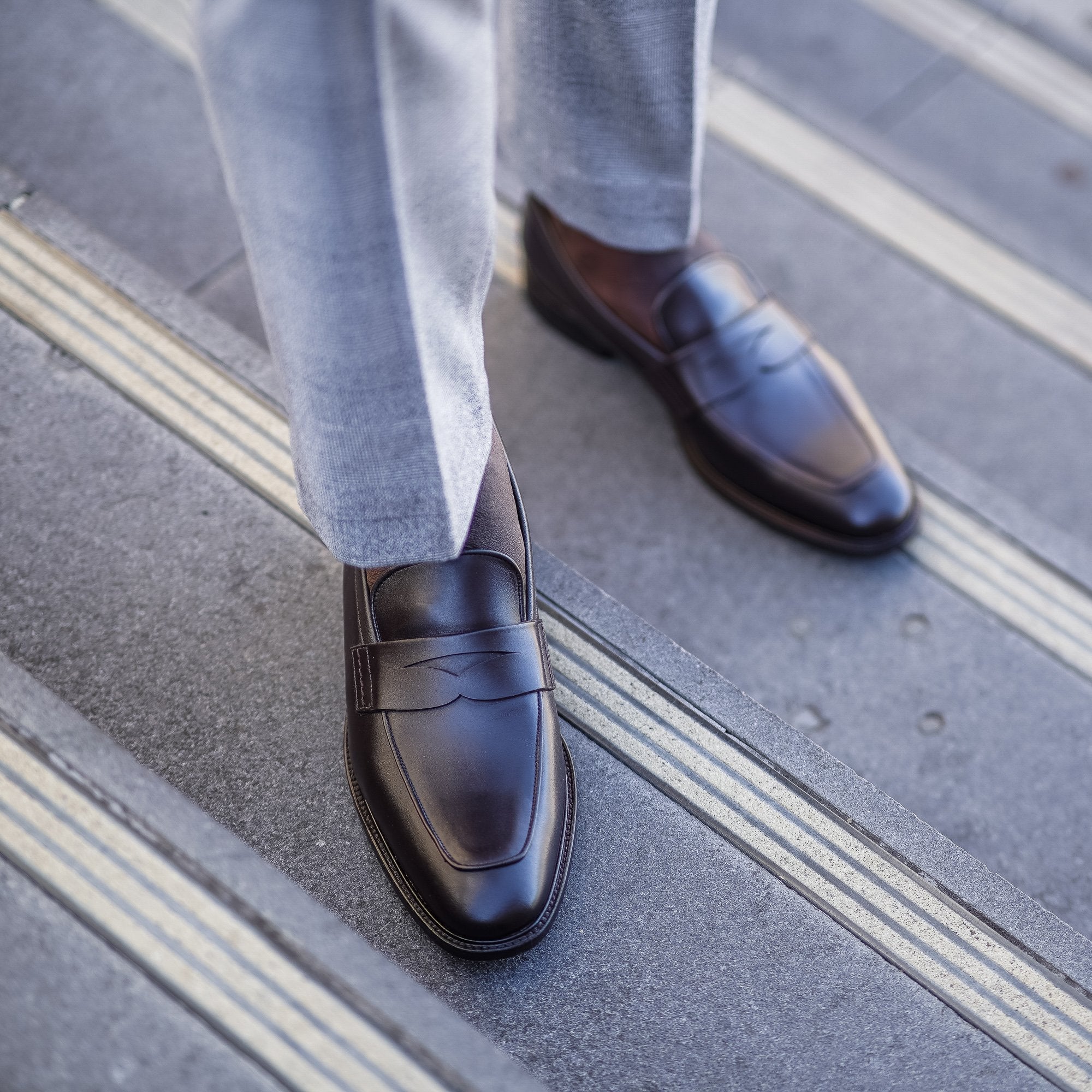 Brown penny loafers paired with tailored business suits