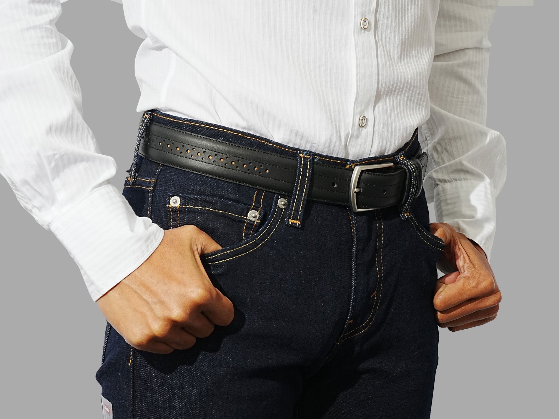 Buy black leather belt with a subtle brogue design. Pair with trousers or dress pants for a formal look