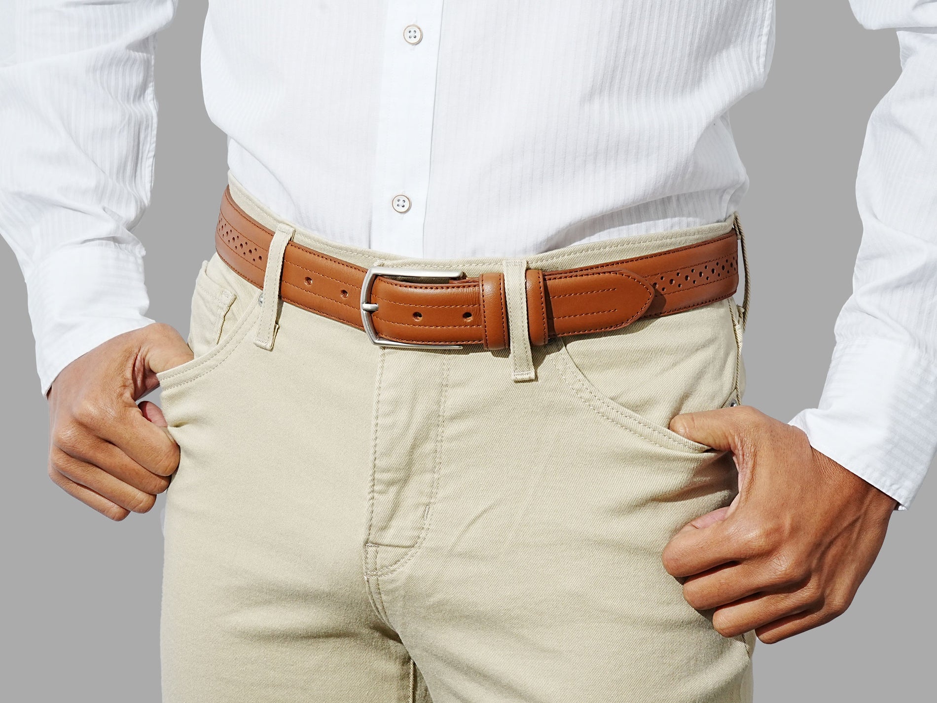 Men’s tan belt with decorative detailing, crafted in Spain. For refined dressing.