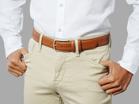 Men’s tan belt with decorative detailing, crafted in Spain. For refined dressing.