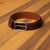 Burgundy leather belt. Brogue detail for men who pair suits with wingtip shoes.