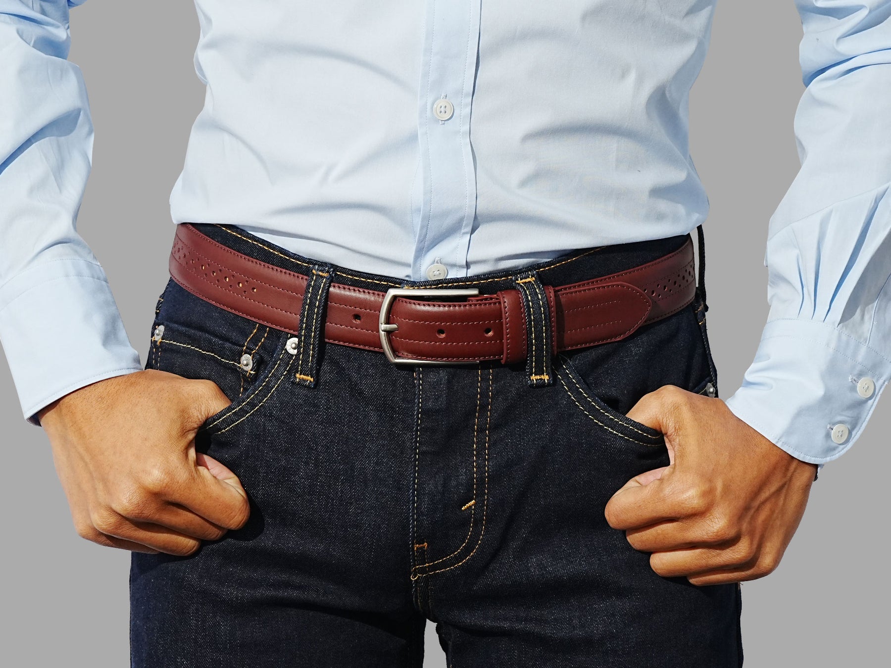 Burgundy belt with decorative perforations. Style with suits or tapered denim.