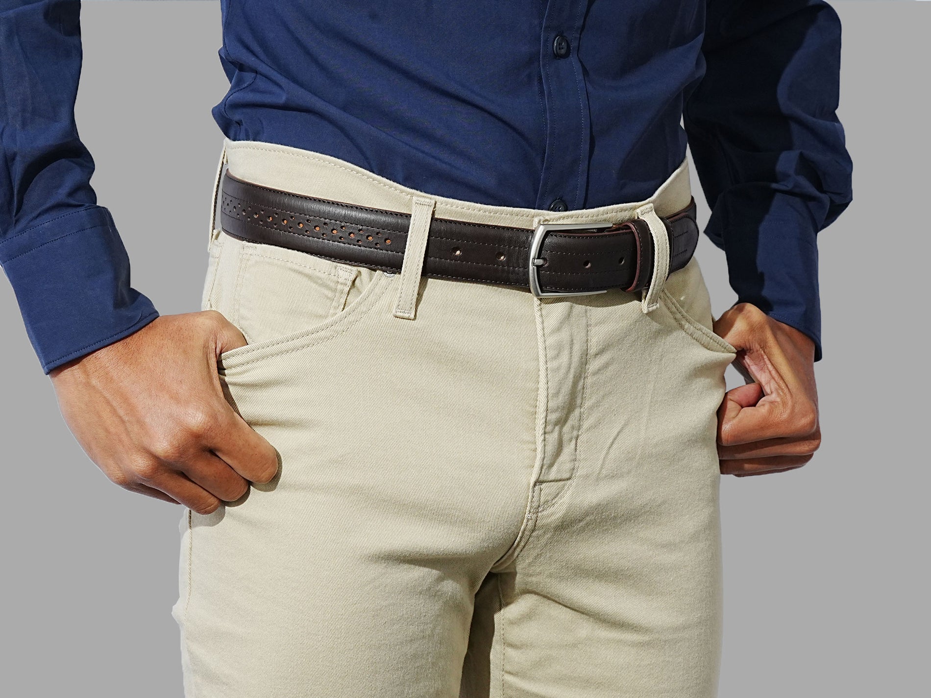 Men leather belt with a subtle brogue design. Pair with trousers or dress pants for a formal look.