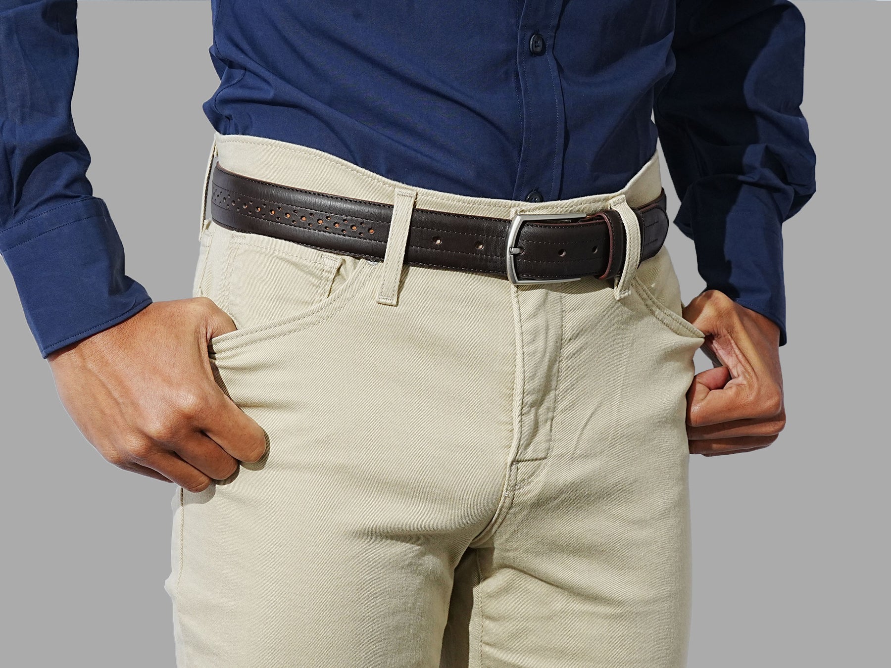 Men leather belt with a subtle brogue design. Pair with trousers or dress pants for a formal look.