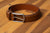 Tan belt with wingtip-inspired detail. Wear it with chinos or structured jackets.