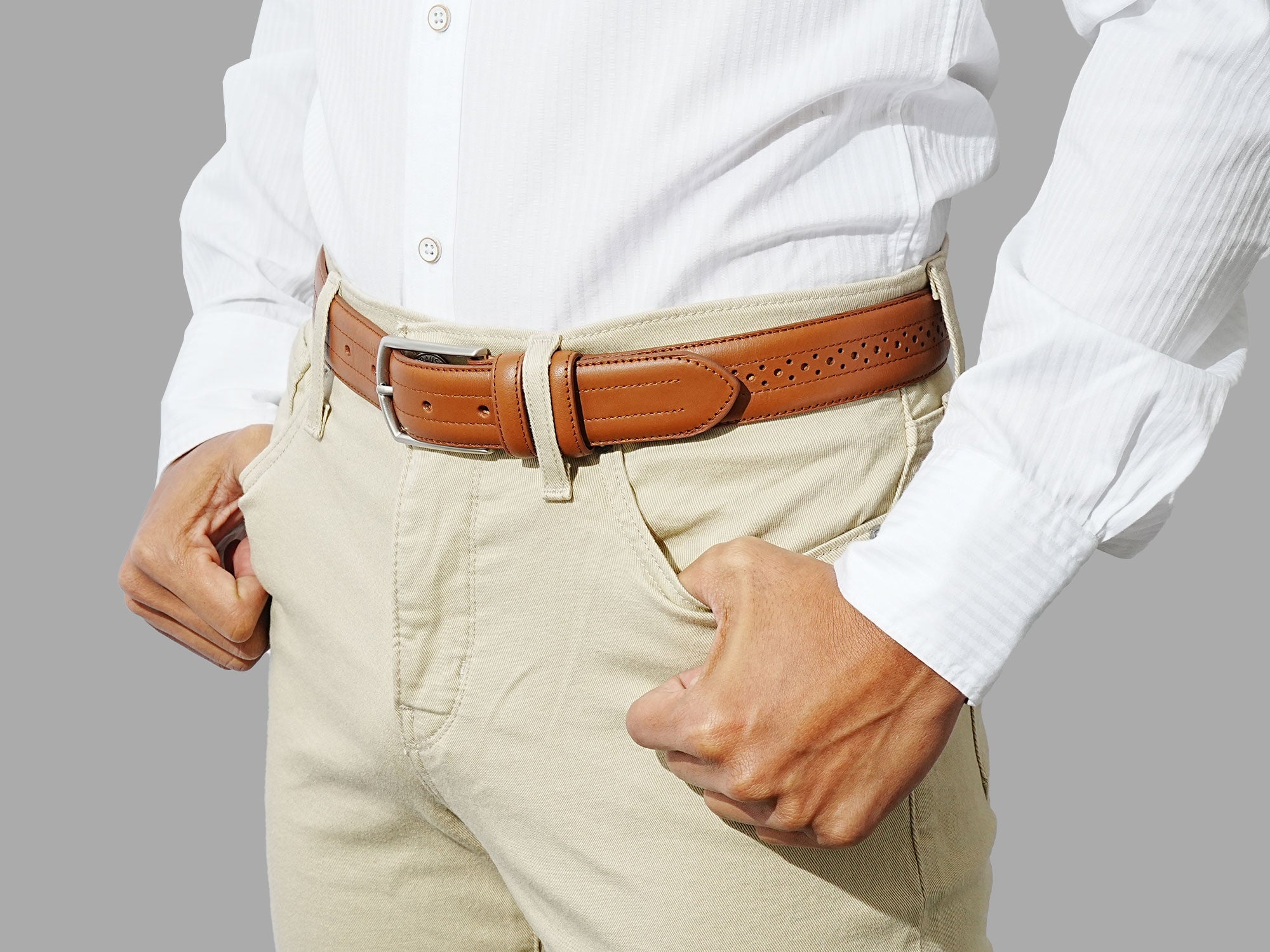 Tan leather belt with ornate perforations. Match with suits or smart 