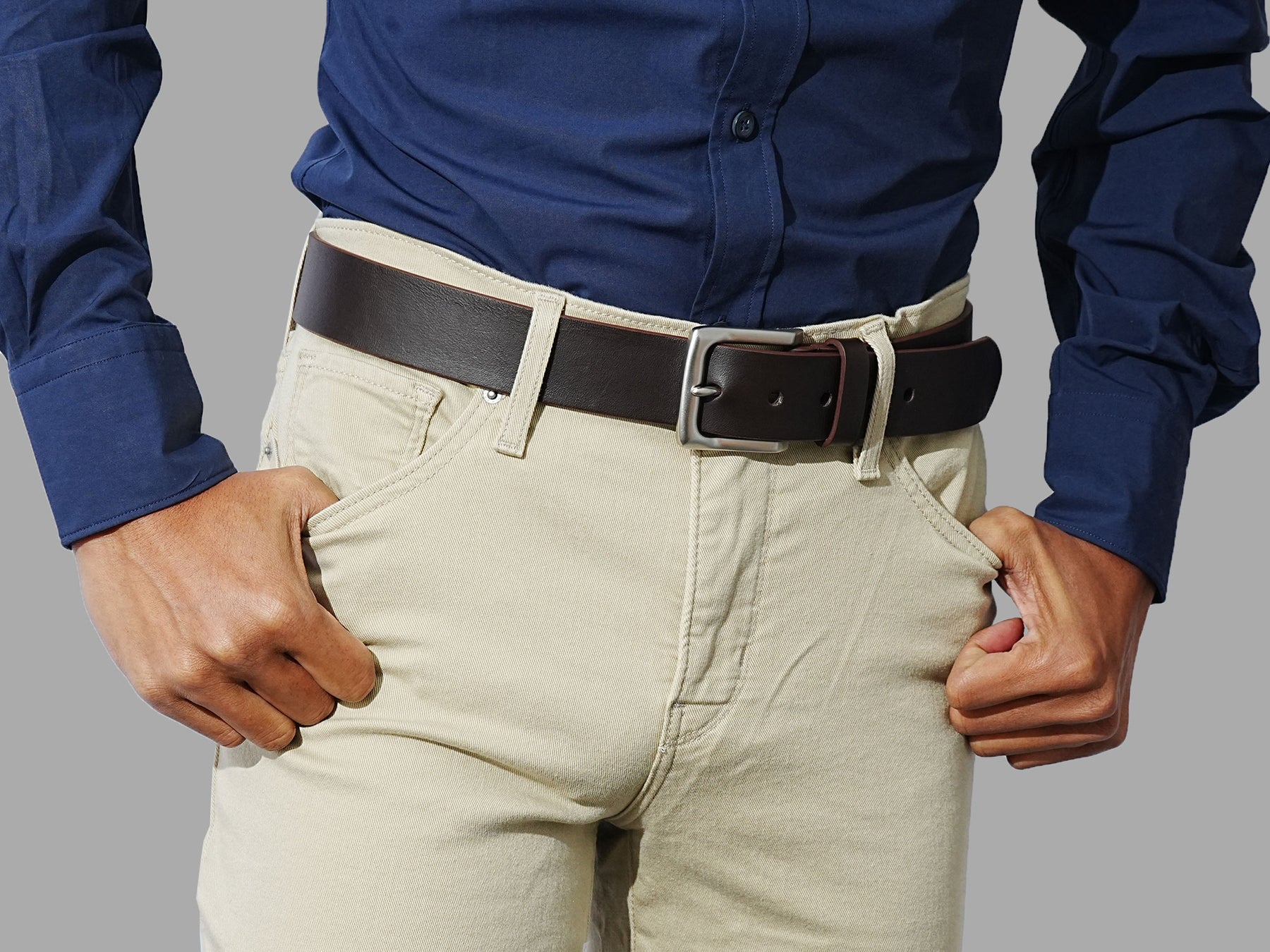 Men’s brown leather belts with solid buckles. Wear with denim, chinos, or smart casual.