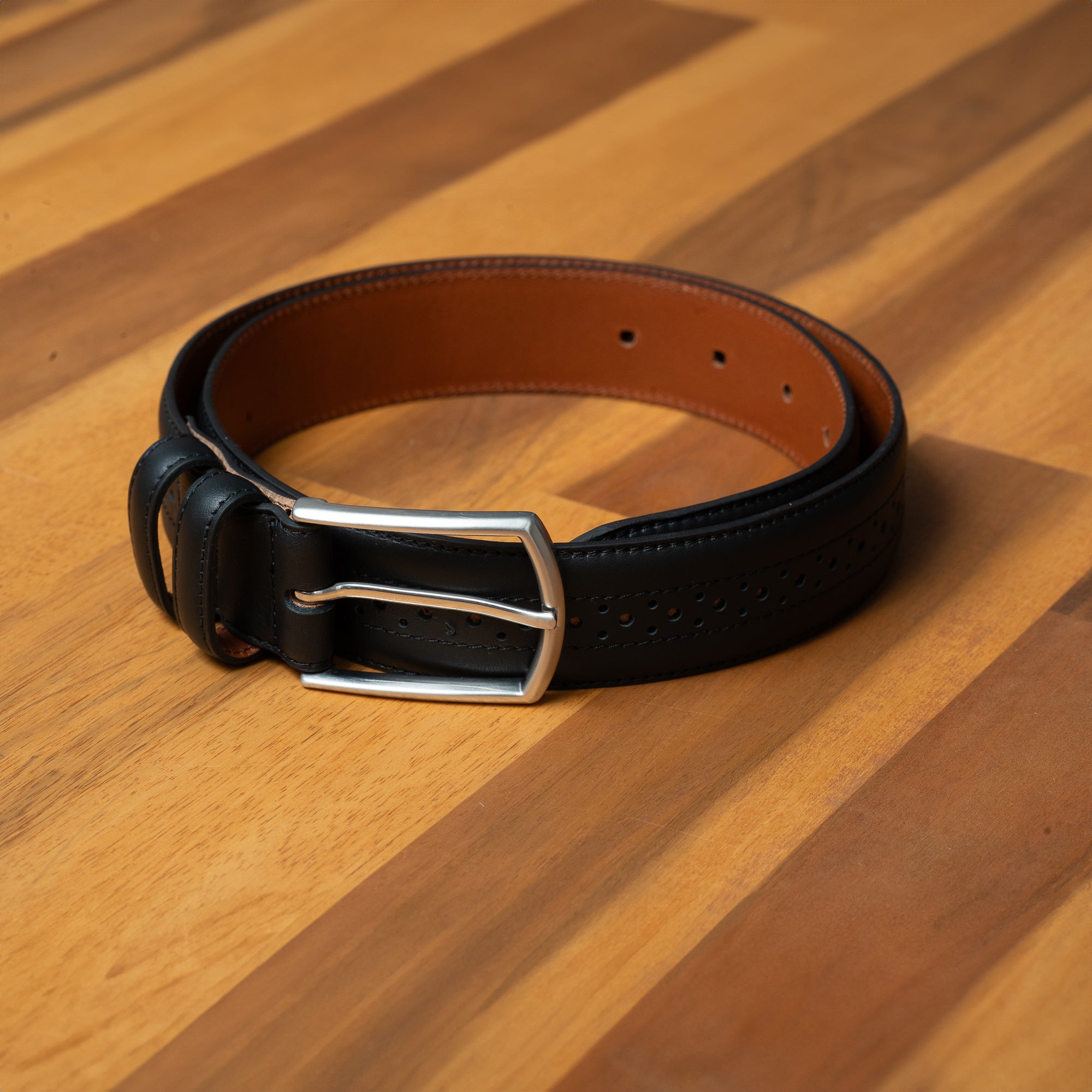Buy smart black belt for men. Brogue details give a classic touch to suits, jeans, and smart casual