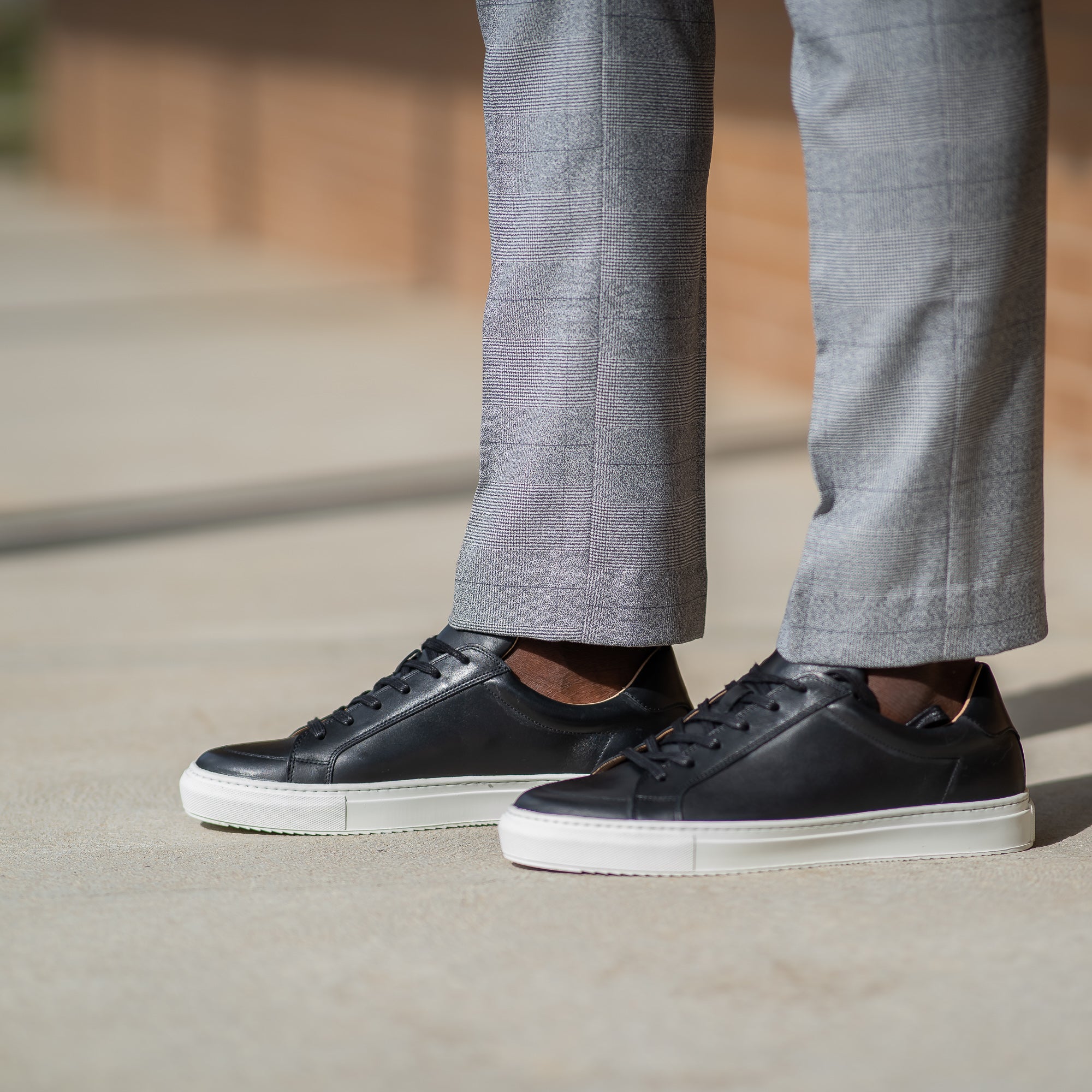 The Vin leather sneakers mens black, paired with slim fit business trousers and blazers for trendy look