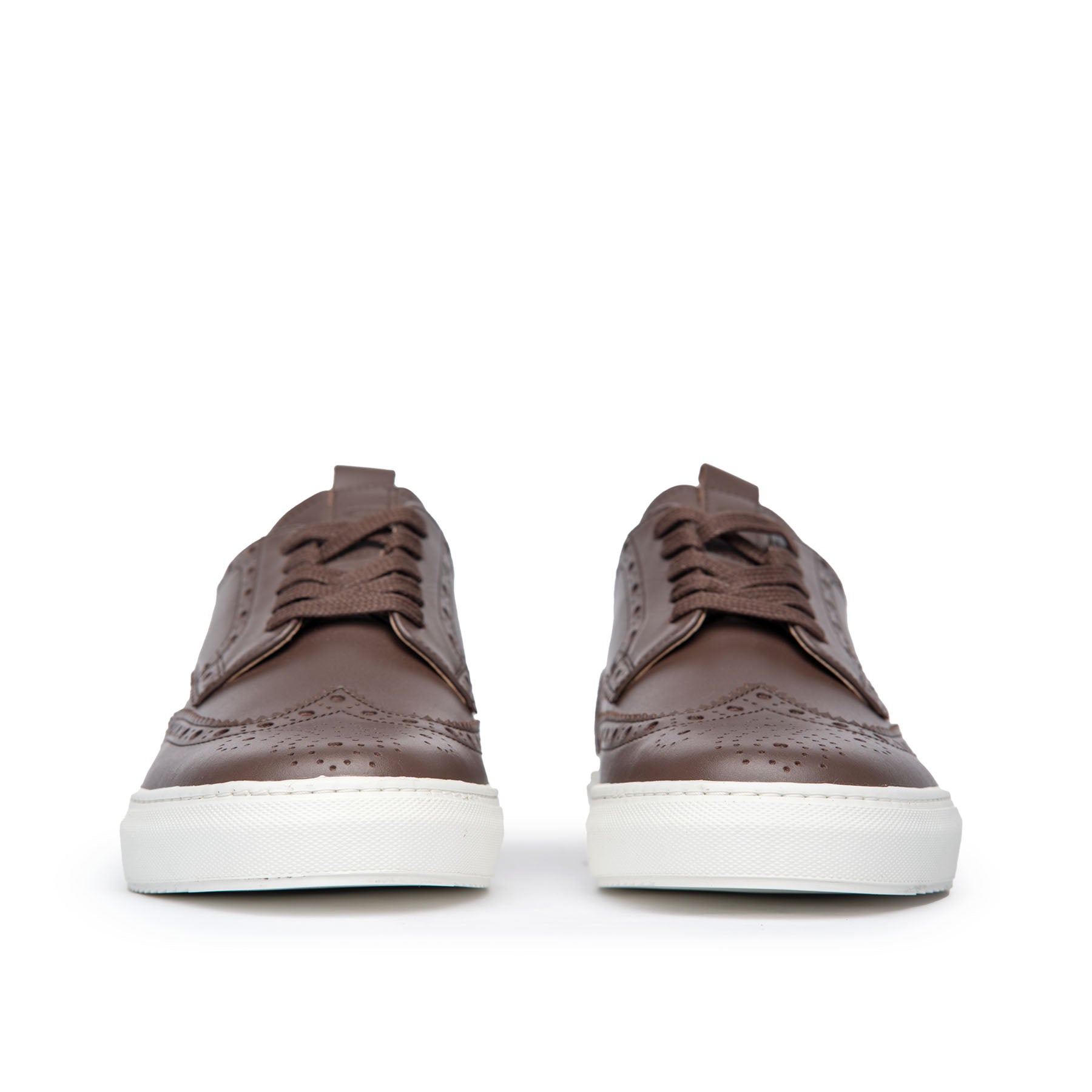 The Alpha low top wingtip sneakers in dark brown leather with medallion on the round toe