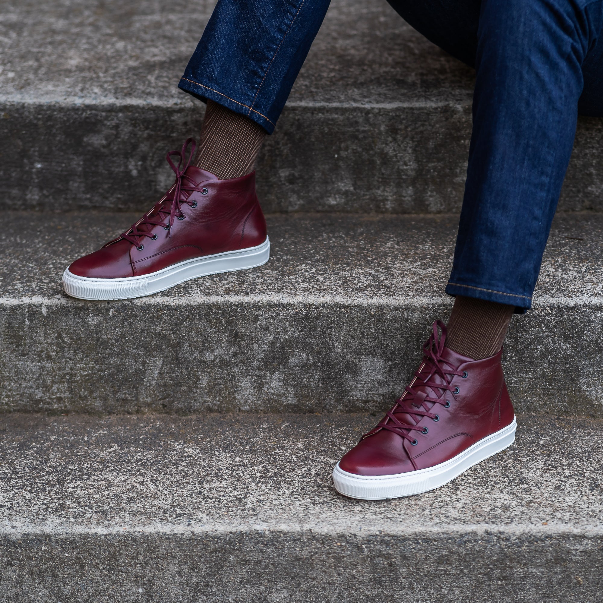 The Explorer high top leather sneakers in burgundy, perfectly matched with black tucker jacket and chinos.