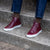 The Explorer hi-top leather sneakers in oxblood, styled with slim jeans and fitted tee shirt