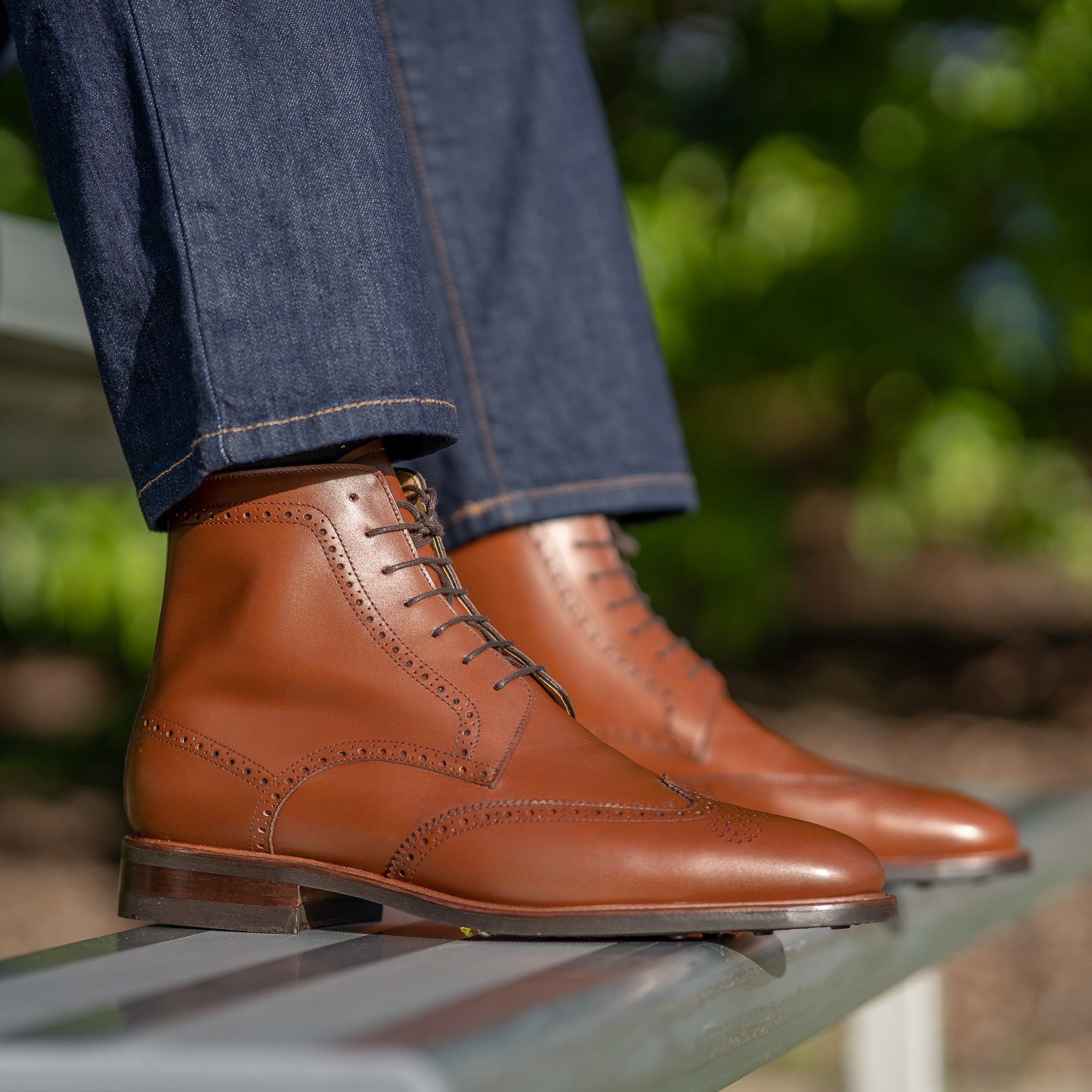 The Outback designer wingtip boot in cognac, vintage calf, paired with navy tweed blazer