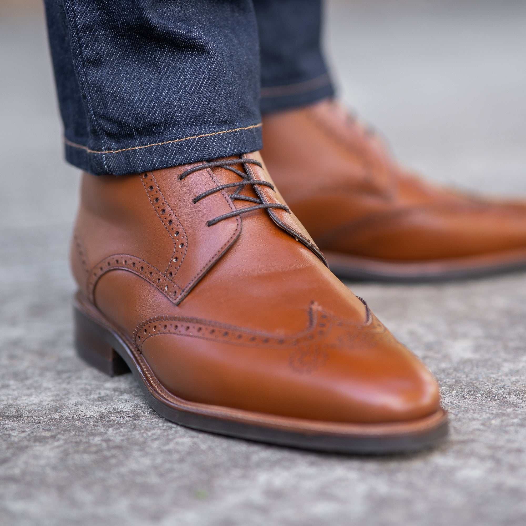 The Outback ankle wingtip leather boot, dressed with dress pant and business tailored shirt for formal occasions