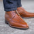 The Outback ankle wingtip leather boot, dressed with dress pant and business tailored shirt for formal occasions