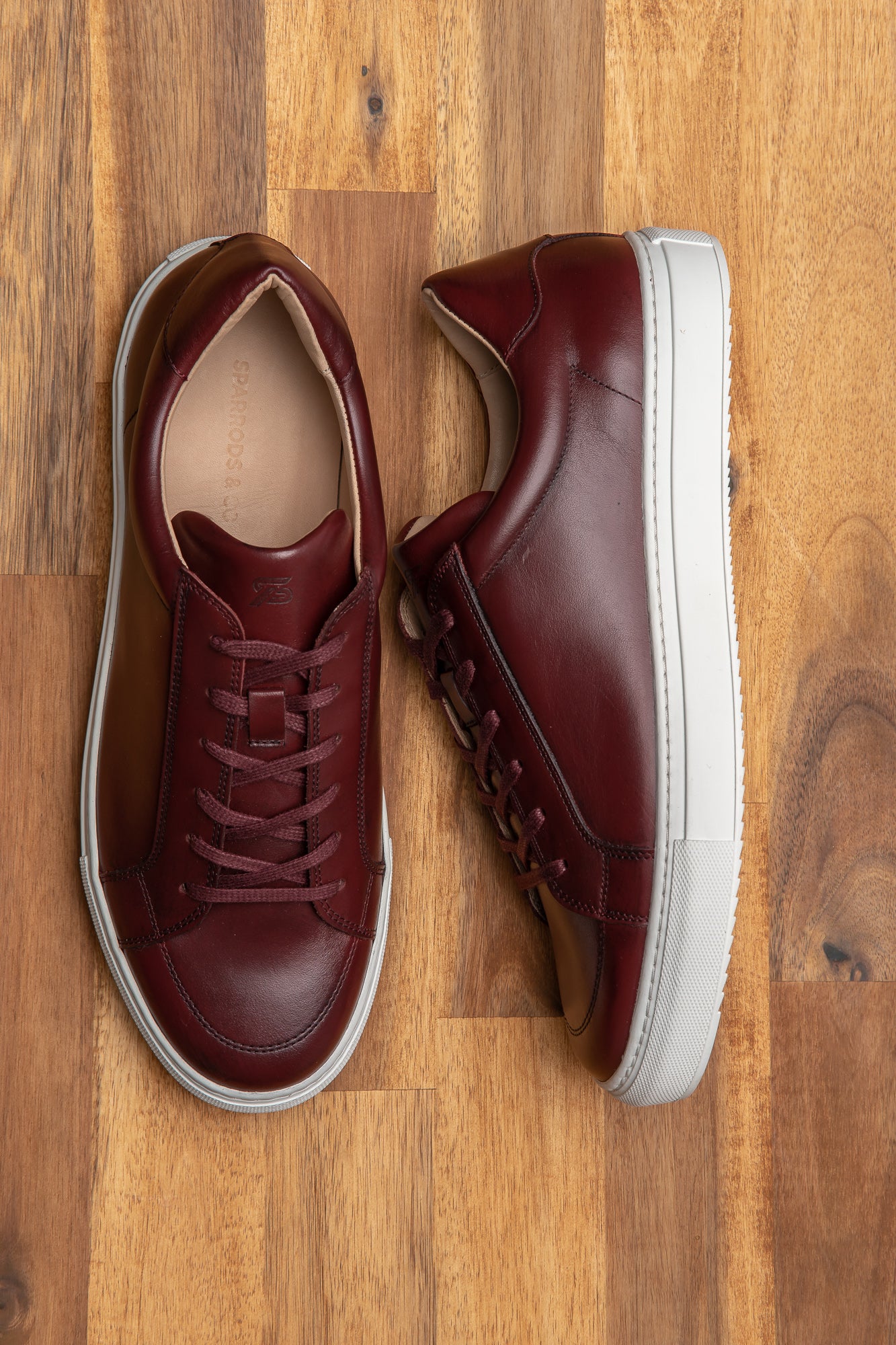 The Vin hand burnished low top leather sneakers in burgundy, excellent silhouette, and sleek design.