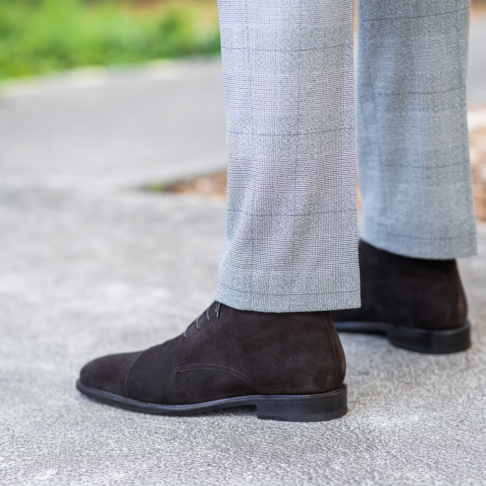 The Sahara lace up boot in dark brown suede, featuring leather welt and styled with bespoke tailored suit