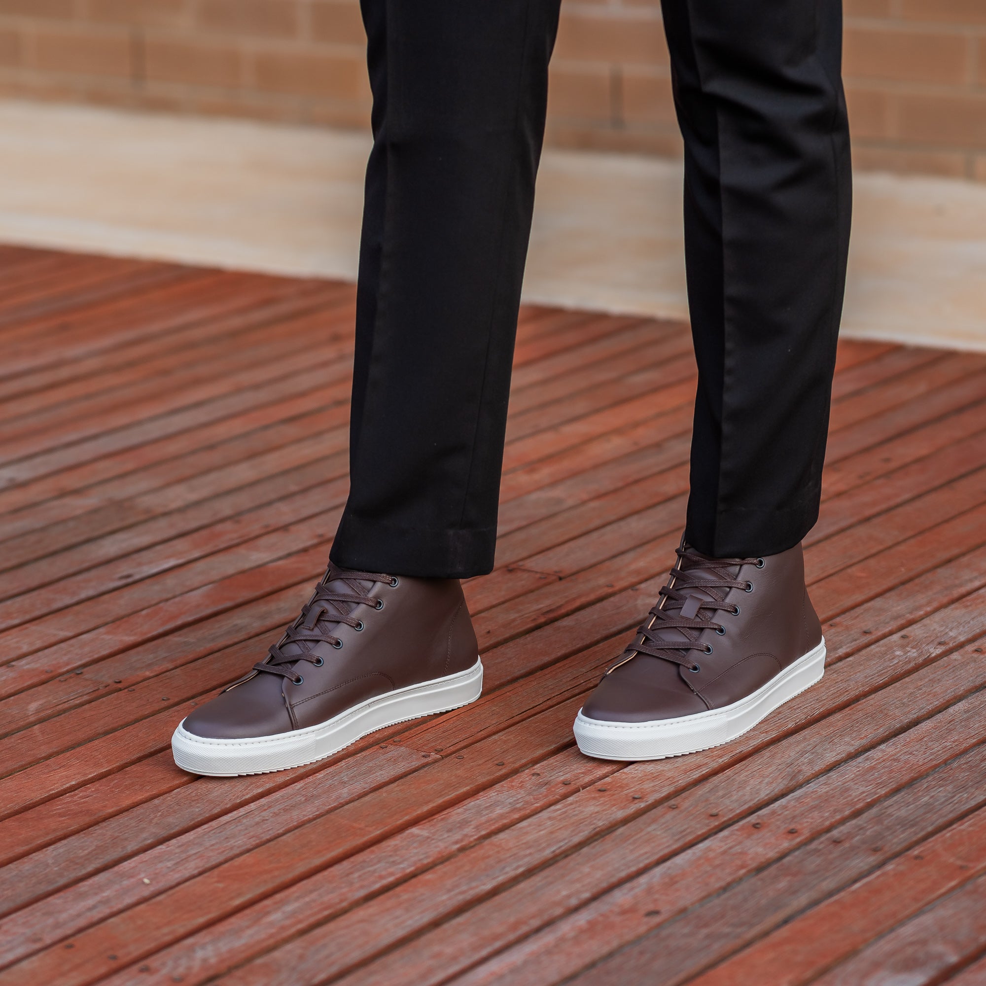 The Explorer handmade high top sneakers in dark brown, paired with dress pants and plain business shirt