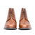 The Outback men’s ankle leather boots, brogue perforation and medallion with patina at the toe cap