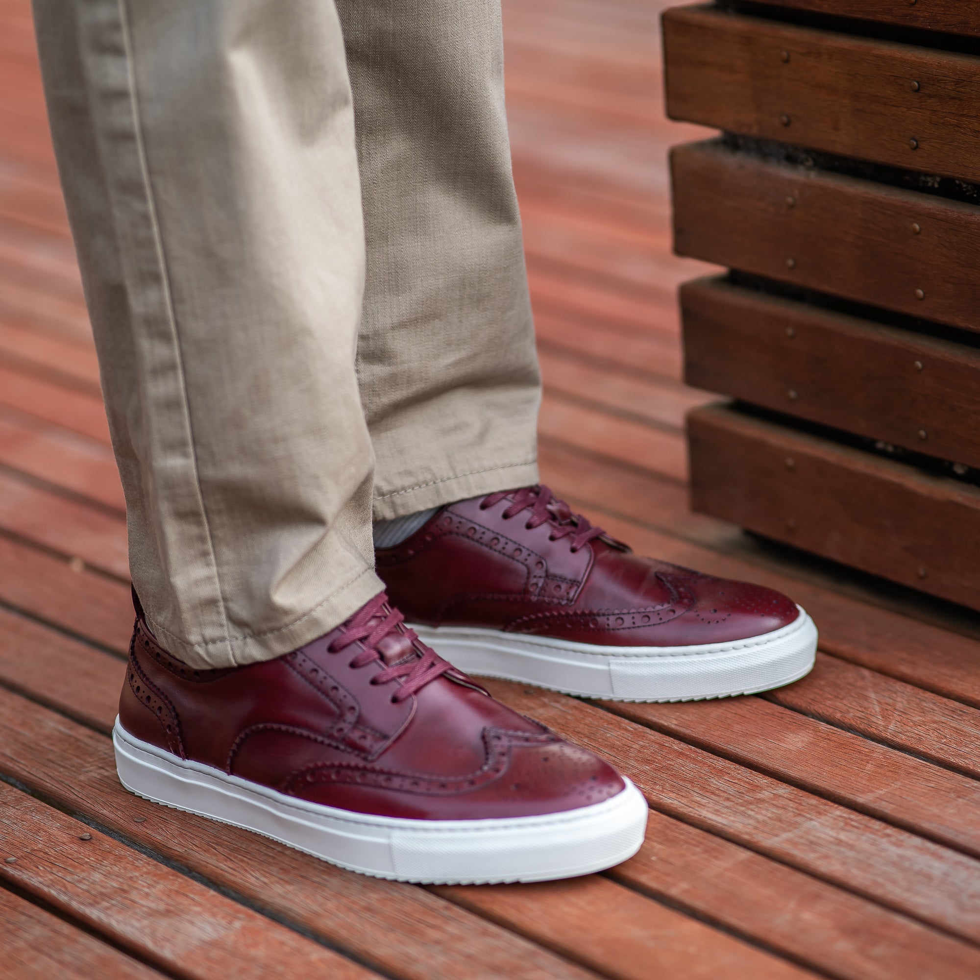 The Alpha brogue trainers in burgundy, styled with casual blazers and slim fit chinos.