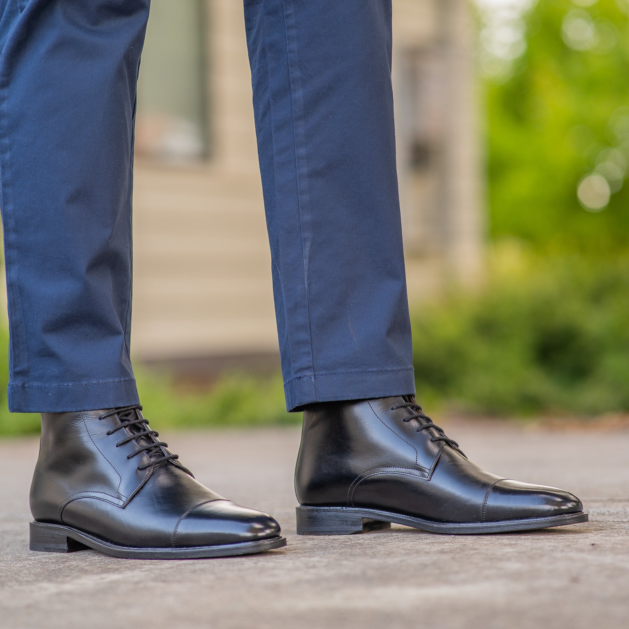 The Sahara mens leather boots black paired with blue chinos with and tailored jacket for casual outfit