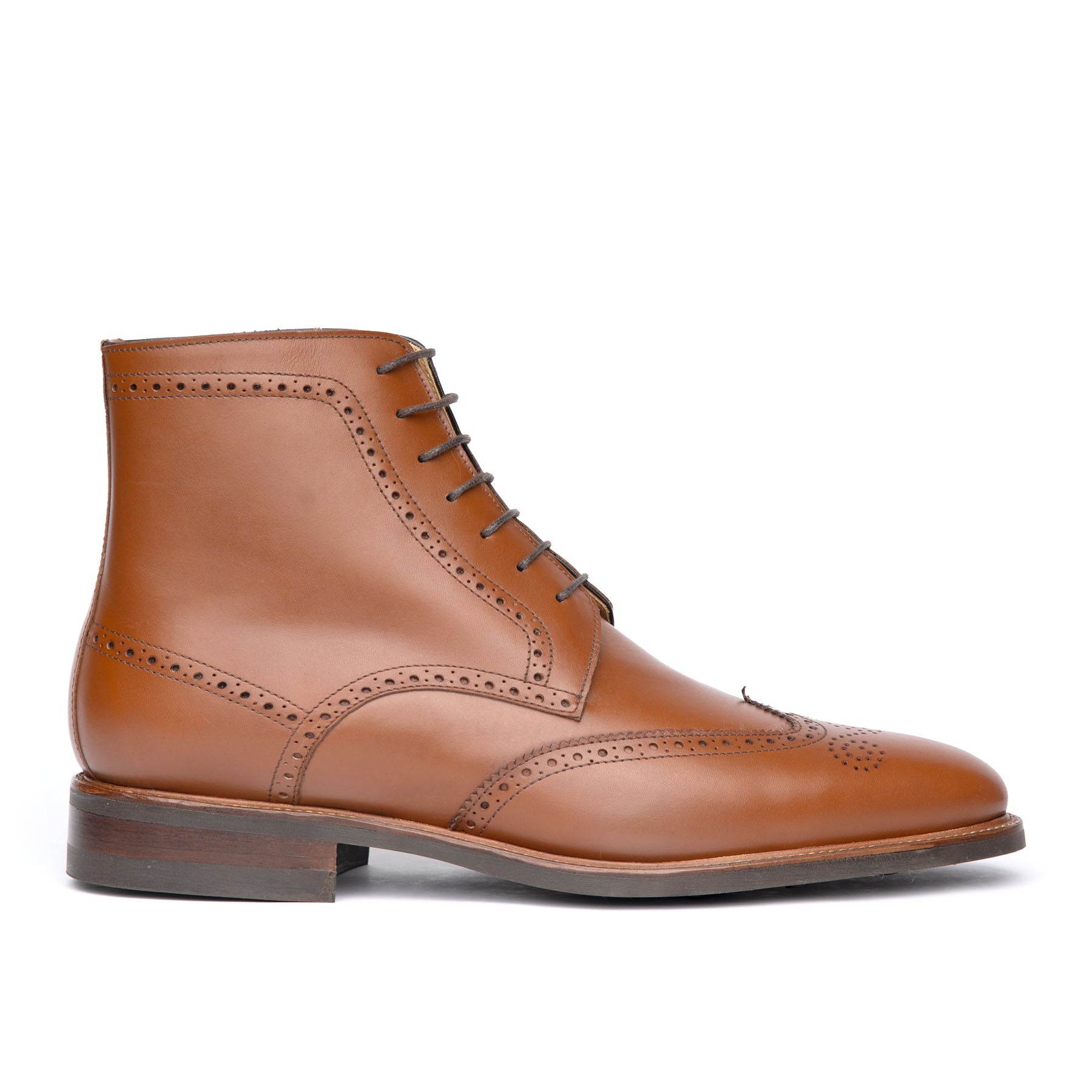 The Outback brogue dress boot in cognac, handmade holes around the boots with 7 lace up fastening and welted construction