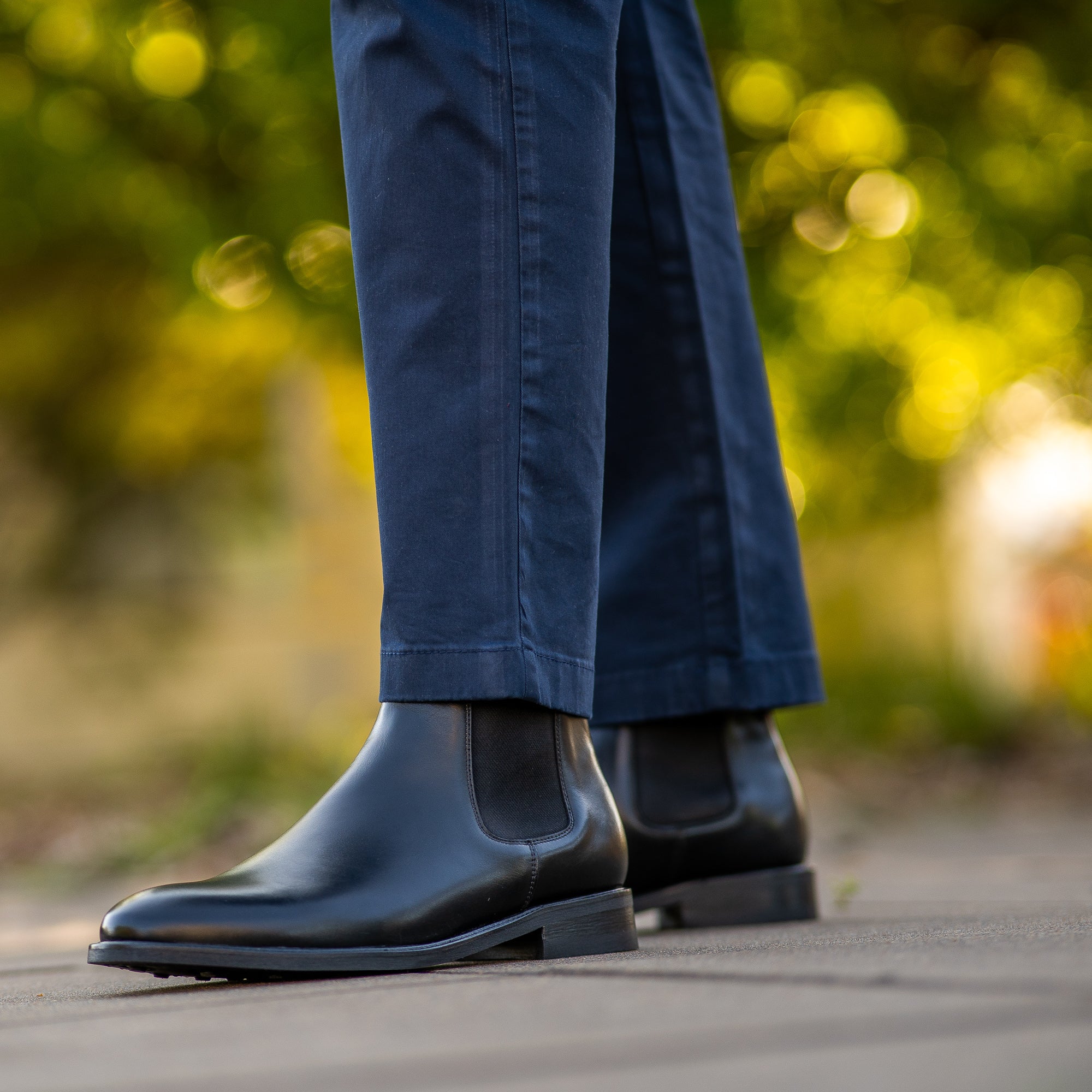 Men in chelsea boots, paired with navy blue chinos and blazer