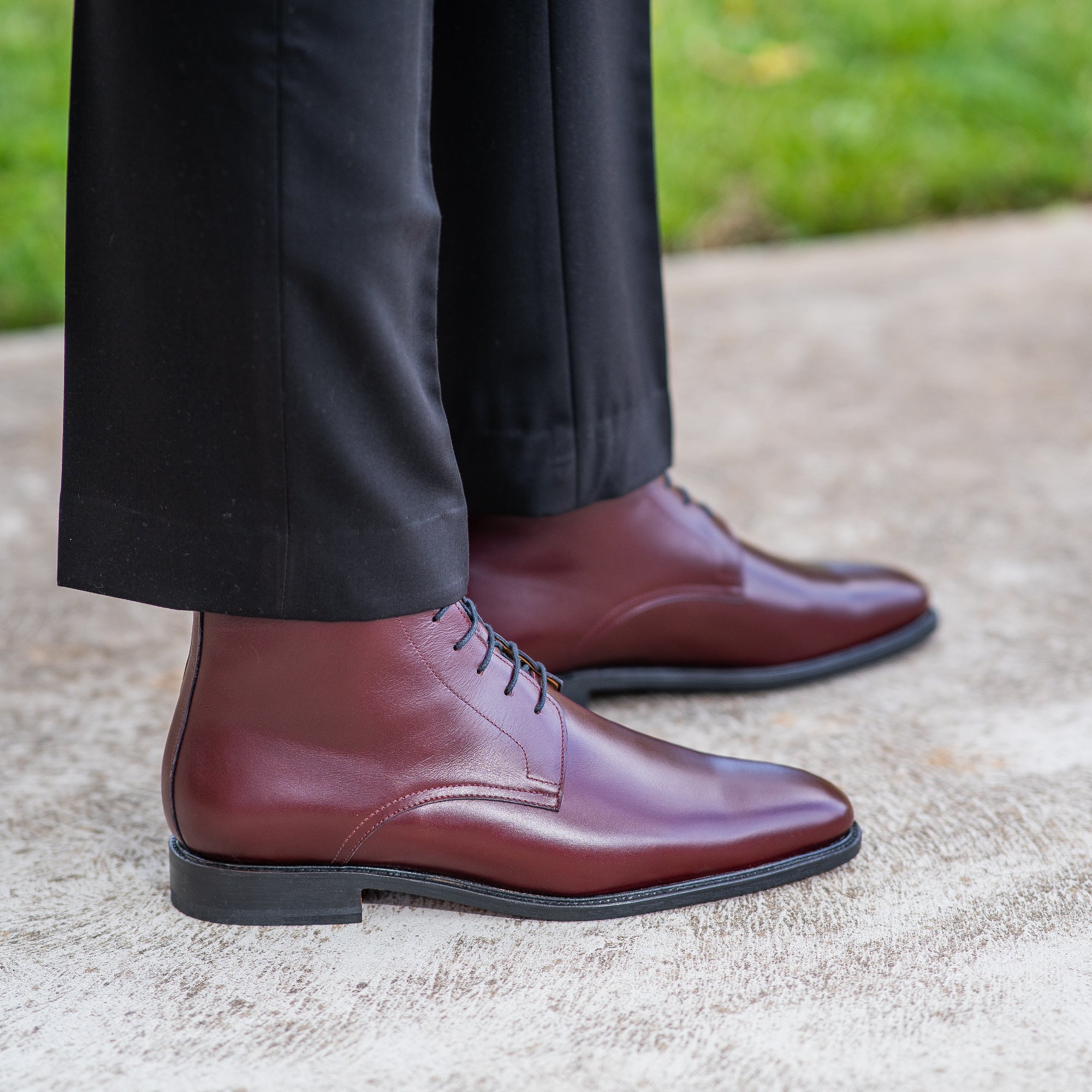 The Kingsman plain toe lace up boot in rich wine leather, paired with bespoke tapered dress pants and merino wool jacket