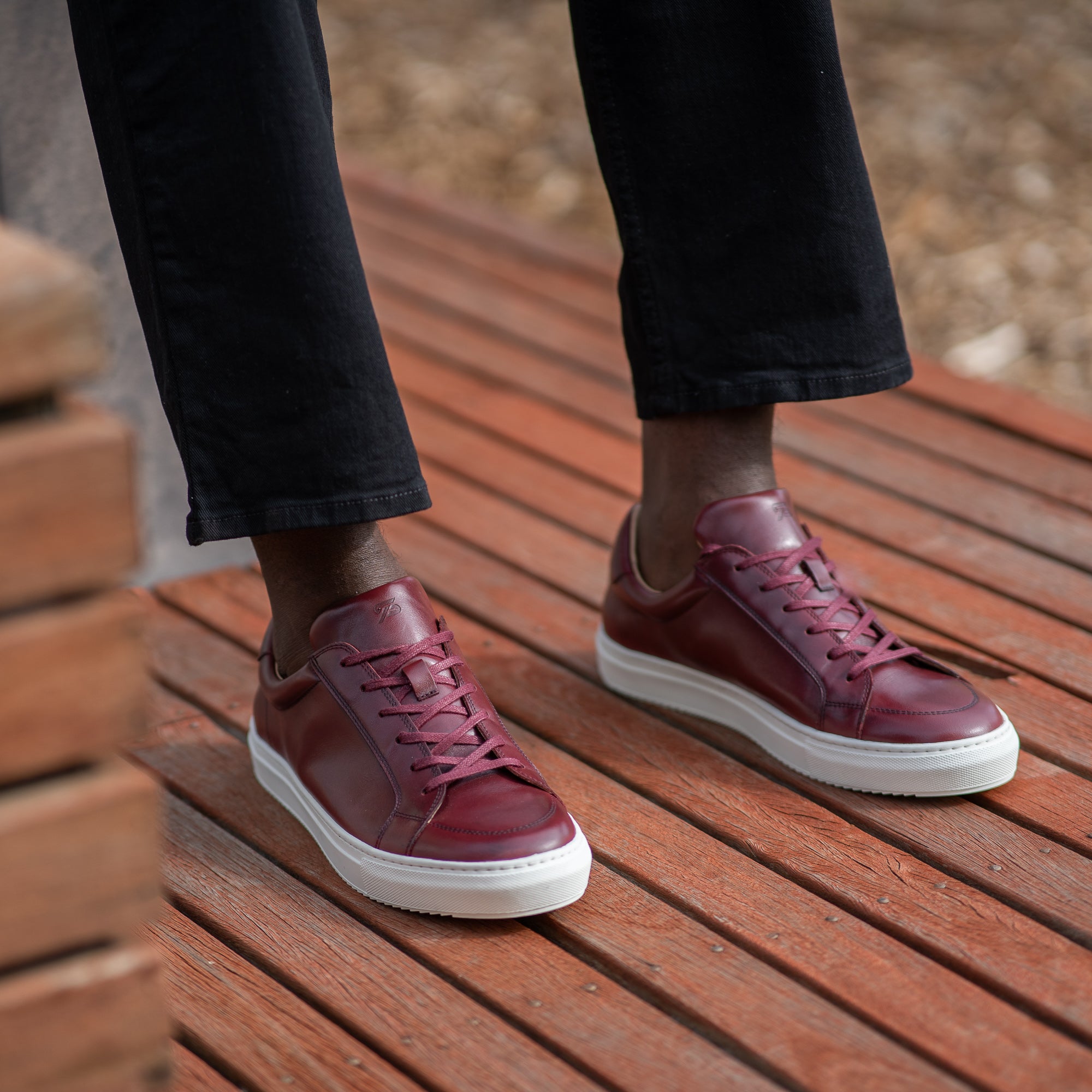 The Vin low top leathers trainers in oxblood, styled with black chinos and business striped shirts 