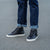 Black leather high top sneaker beautifully paired denim and cotton shirt