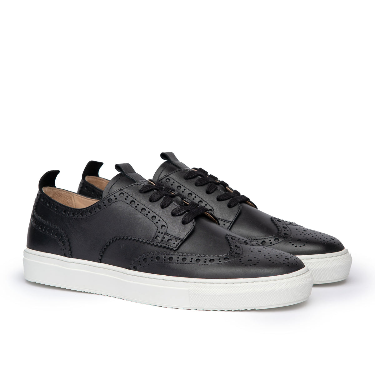 The Alpha full brogue low top sneakers in black leather featuring pull tabs and front lace.